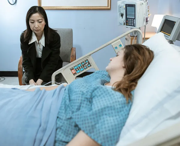 Comfortable mattress support on hospital cot – thick orthopedic foam mattress providing pressure relief and body support for bedridden patients at home