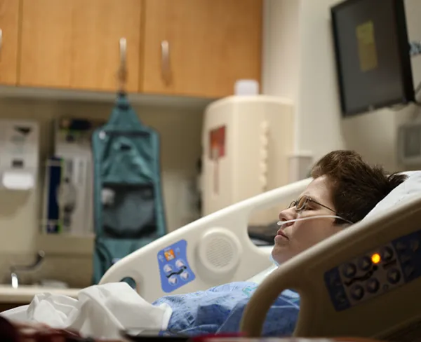 Post-surgery recovery care at home – trained nurse assisting patient with wound dressing and health monitoring after surgery